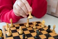 A close-up of a mans hand and chess. Sports and games