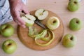Close-up of man`s hand cutting golden apples