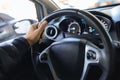 Close-up of a man`s hand holding the steering wheel of a car Royalty Free Stock Photo