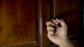 close up of man's hand knocking on the door