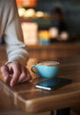 Close up of man's hand with latte art coffee cup in cafe, selective focus, food and drink concept Royalty Free Stock Photo