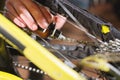 Close-up of a man`s hand, led by masters, lubricate the bicycle chain of a mountain bike with a special lubricant in the Royalty Free Stock Photo