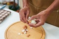 Close-up of a man\'s hand peeling a hard-boiled egg to prepare the salad and sandwiches for breakfast. Before going to work Royalty Free Stock Photo