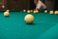 Close-up of a man& x27;s hand playing billiard on a green pool table