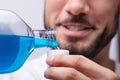 Man Pouring Mouthwash In To Cap Royalty Free Stock Photo
