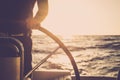 Close up of man`s hand on sail boat helm - marine ship lifestyle concept of travel for beautiful holiday destination - alternativ