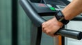 Close-up of a man`s hand with a smartwatch with an application icon on a treadmill. Cardio training concept in a gym Royalty Free Stock Photo