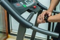 Close-up of a man`s hand with a smartwatch with an application icon on a treadmill. Cardio training concept in a gym Royalty Free Stock Photo