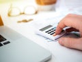 Close up of man`s hand tiping on calculator, planning and analyzing Royalty Free Stock Photo