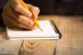 Close Up on a man`s hand writing on paper with a pencil Royalty Free Stock Photo