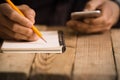 Close Up on a man`s hand writing on paper with a pencil Royalty Free Stock Photo