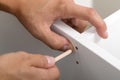 Close-up of man's hands assembling furniture