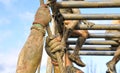 Close-up of man's hands climbing the rope