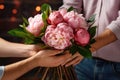 Close-up of man\'s hands giving bouquet of flowers to male arms. Florist holds bouquet of peonies Ai, Ai Generated