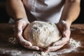 Close up of man\'s hands holding dough for bread baking