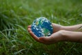 Close-up of a man& x27;s hands holding a globe of the earth. Earth Day Concept Save the World save the environment Royalty Free Stock Photo