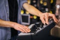 Close up of man`s hands on keyboard. Guy turn sound on. He stand in room. Many sound speakers are behind him.