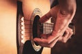 Close up a man`s hands playing acoustic guitar. Playing acoustic guitar at a recording studio Royalty Free Stock Photo
