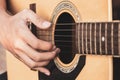 Close up a man`s hands playing acoustic guitar. Playing acoustic guitar at a recording studio Royalty Free Stock Photo