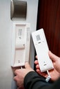 Close-up of man\'s hands pressing a button on a digital intercom Royalty Free Stock Photo