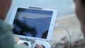 Close-up of man`s hands with a remote control flying a small quadcopter toy at nature Royalty Free Stock Photo