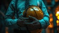 close-up of a man& x27;s hands in a suit holding a construction helmet. Concept of downshifting office workers into blue