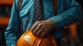 close-up of a man& x27;s hands in a suit holding a construction helmet. Concept of downshifting office workers into blue