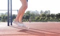 Close-up of a man`s legs jumping rope in a park during an exercise routine