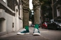 Close-up of a man& x27;s stylish shoes and quirky socks standing on the street.