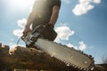 Close-up of a man sawing a log with a chainsaw Royalty Free Stock Photo