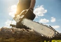Close-up of a man sawing a log with a chainsaw Royalty Free Stock Photo