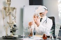 Close up of man scientist wearing vr goggles and holding flask, making test in clinical laboratory. Doctor scientist Royalty Free Stock Photo