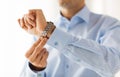 Close up of man in shirt fastening wristwatch