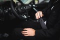 Close-up of man sitting in car fastening seat belt Royalty Free Stock Photo