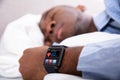 Man Sleeping With Smart Watch In His Hand Royalty Free Stock Photo