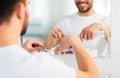 Close up of man squeezing toothpaste on toothbrush Royalty Free Stock Photo