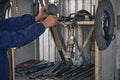 Close up of man standing near shelving with tools