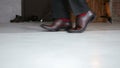 Close-up of man in stylish shoes dancing, moonwalk