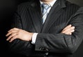 Close up of a man in a suit with his hands arms crossed Royalty Free Stock Photo