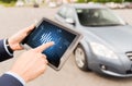 Close up of man with tablet pc diagnoses car Royalty Free Stock Photo