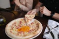 Close up of man take slice of pizza in restaurant