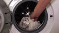 Close-up of a man taking clothes out of the washing machine