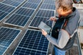 Close up of man technician using application. Checking solar panel setup. Royalty Free Stock Photo