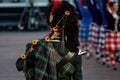 Close up of a man in traditional Scottish attire is playing the traditional Scottish bagpipes Royalty Free Stock Photo