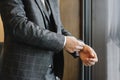 Close-up of a man in a tux fixing his cufflink. groom bow tie cufflinks. Royalty Free Stock Photo