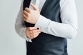 Close-up of a man in a tux fixing his vintage cufflink. groom bow tie cufflinks