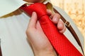 Close up of man tying a red tie Royalty Free Stock Photo