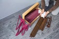 close up man unpacks a box of furniture parts and holds plastic connectors in his hands. Royalty Free Stock Photo