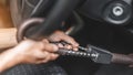 Close up of man use key locking steering wheel for security, Anti thief steal a car, Selective focus