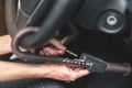 Close up of man use key locking steering wheel for security, Anti thief steal a car, Selective focus